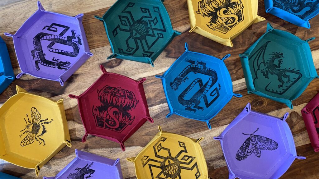 Handmade dice trays printed with fantasy monsters.